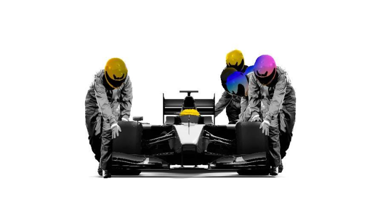 Race car with a driver in a helmet in it, with three other people in helmets pushing the race car along.